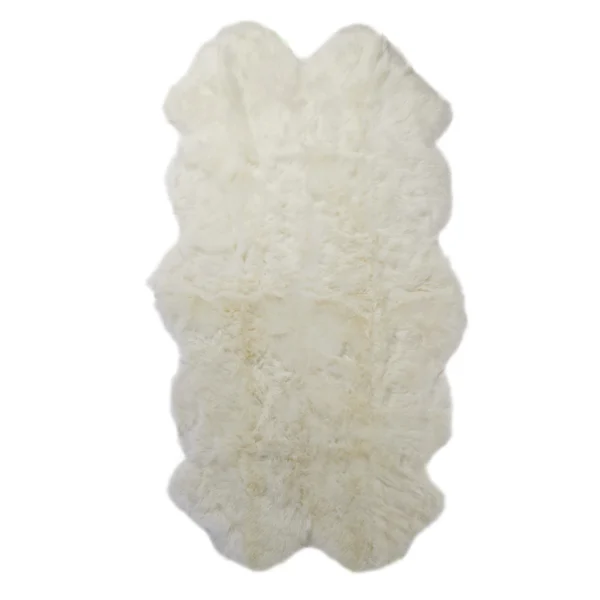 A Natural White Quad Sheepskin Rug with scalloped edges, a soft and plush texture, appears fluffy and rectangular. Photographed against a plain white background.