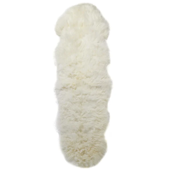 The Natural White Double Sheepskin Rug features a soft, thick texture and an irregular pelt shape with uneven edges, adding a cosy and plush touch to your home décor.