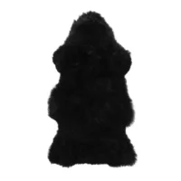 An Extra Large Blue Sheepskin Rug with a soft, shaggy texture and irregular, fluffy edges is displayed against a white background, resembling natural hide.