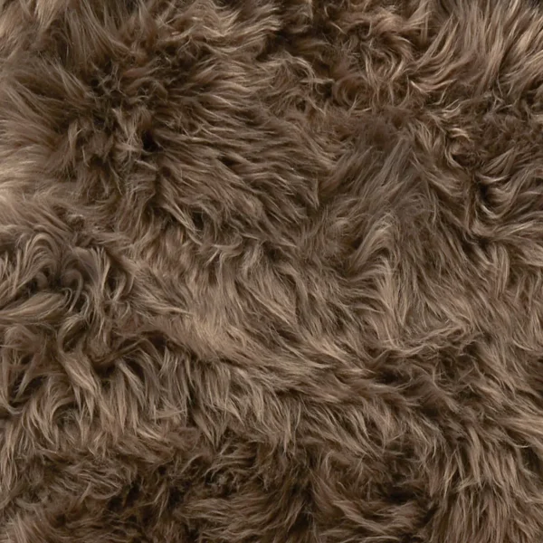 Close-up of the Taupe Sheepskin Rug - Extra Large, featuring long, wavy strands in varied brown shades. The soft, fluffy texture and dense material create a natural and cosy look that fills the entire frame.