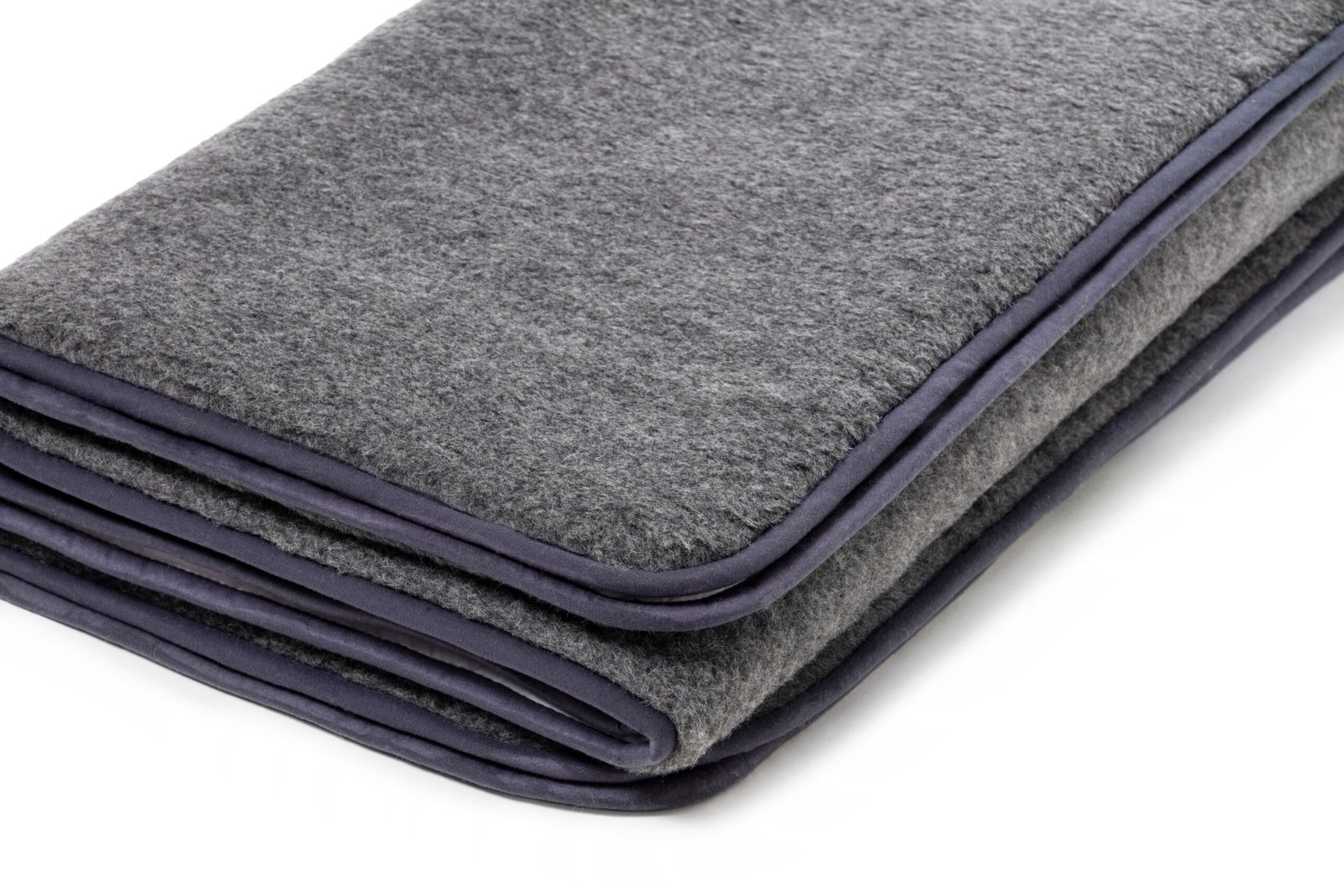 Simply Sheepskin large grey merino wool blanket draped on sofa