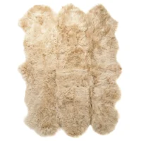 The Champagne 6 Pelt Sheepskin Rug features multiple sewn sheep pelts, creating a soft, fluffy texture with natural variations in length and shade, and an irregular edge for a cosy, organic look.